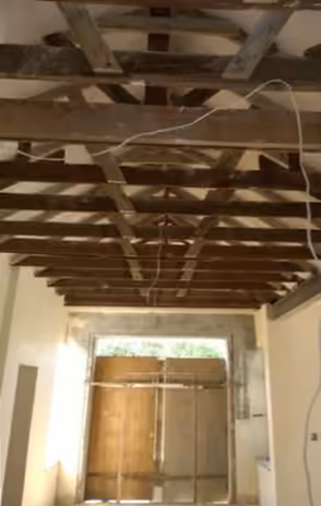 Before: stripped roof trusses and bare walls