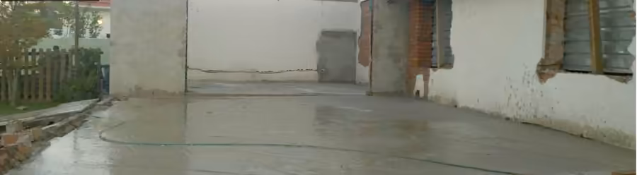 Before: bare concrete slab and exposed brick at the back of a house
